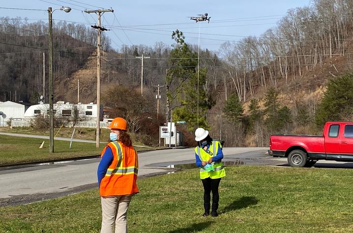 This is a photo of Kentucky Homeplace community health workers Chyna Smith, left, and Carole Frazier retrieving a package delivery from a drone. Photo courtesy of CERH.