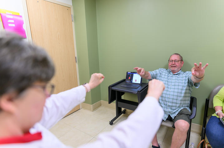 This is a photo of Hoyt “Corky” Ball going through some assessments at a routine DBS-Plus follow up appointment with Julie Gurwell, Ph.D. (Photo by Shaun Ring).