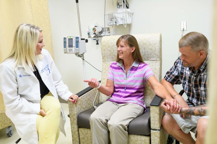 This is a photo of research nurse Heather Heath with Jenn and Tyrome Highfield inside the Precision Medicine Clinic at Markey Cancer Center.