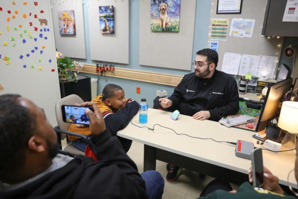 This is a photo of DuJuan Broadus Jr. and his parents at his cochlear implant activation appointment on Jan. 9. Carter Skaggs | UK Photo