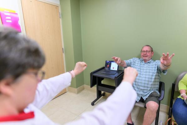 This is a photo of Hoyt “Corky” Ball going through some assessments at a routine DBS-Plus follow up appointment with Julie Gurwell, Ph.D. (Photo by Shaun Ring).