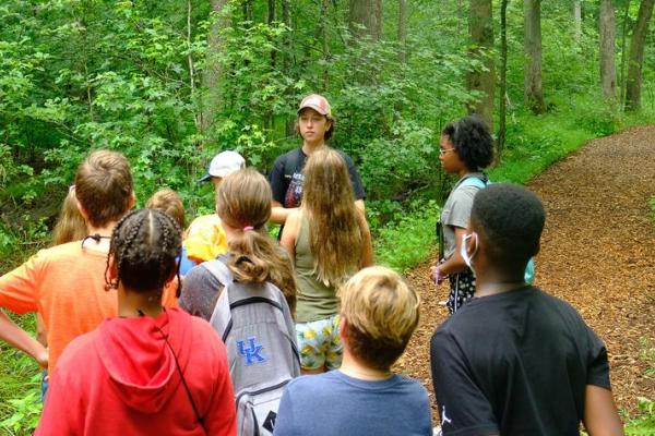 This is a photo of High school students learning though hands-on activities such as tree identification. Photo by Matt Barton.