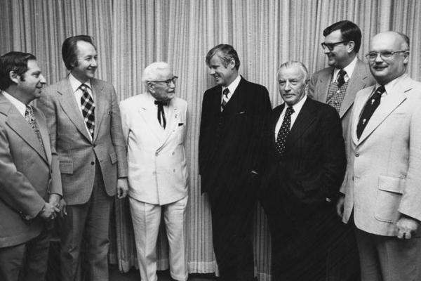 This is a photo of Col. Harland Sanders; Gov. John Y. Brown Jr.; John Y. Brown Sr.; UK VP Ray Hornback; and Medical Center Chancellor Peter Bosomworth at the building dedication. Wade Hall Collection of American Letters, UK Libraries Special Collections Research Center
