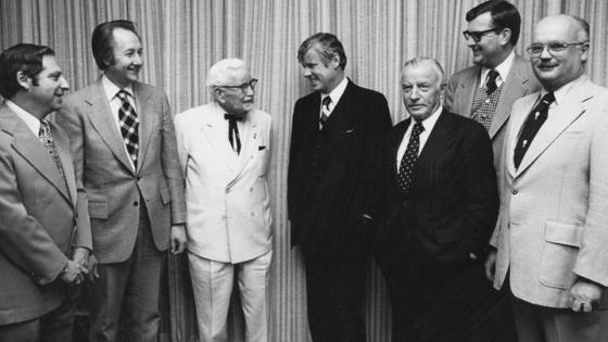 This is a photo of Col. Harland Sanders; Gov. John Y. Brown Jr.; John Y. Brown Sr.; UK VP Ray Hornback; and Medical Center Chancellor Peter Bosomworth at the building dedication. Wade Hall Collection of American Letters, UK Libraries Special Collections Research Center